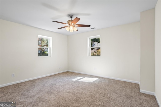 empty room with ceiling fan and carpet