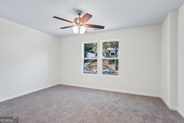 spare room featuring ceiling fan and carpet floors