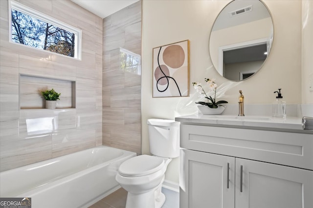 bathroom with tile patterned flooring, vanity, toilet, and a tub to relax in