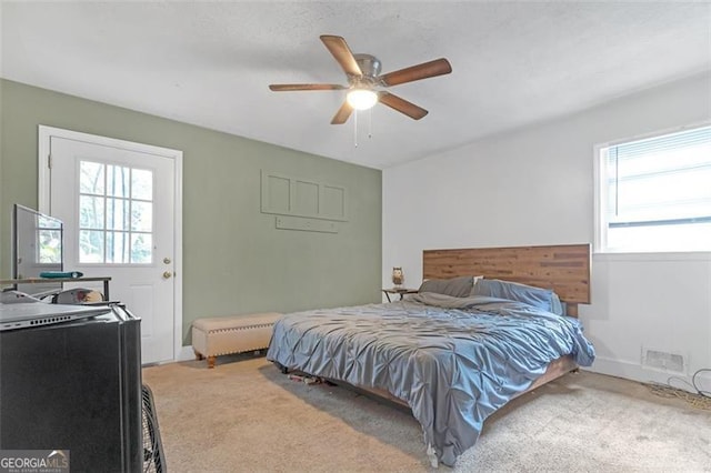 bedroom with ceiling fan and carpet