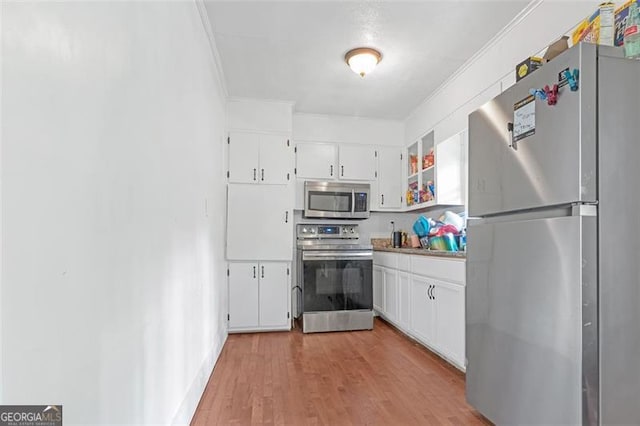 kitchen featuring white cabinets, light hardwood / wood-style floors, and stainless steel appliances