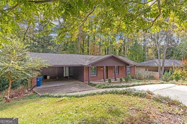 ranch-style home with a front yard and a carport