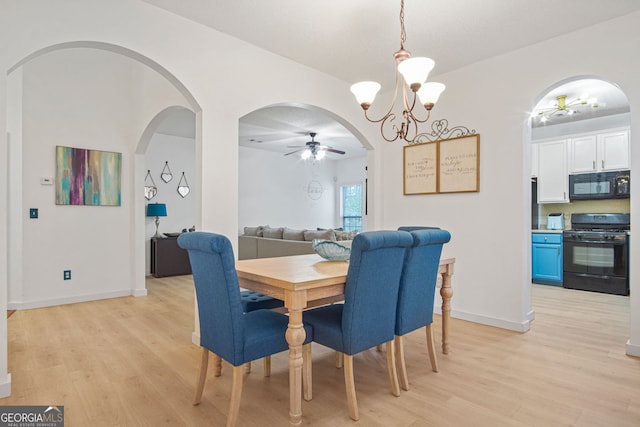 dining area featuring ceiling fan with notable chandelier and light wood-type flooring