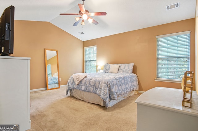 carpeted bedroom featuring ceiling fan and vaulted ceiling