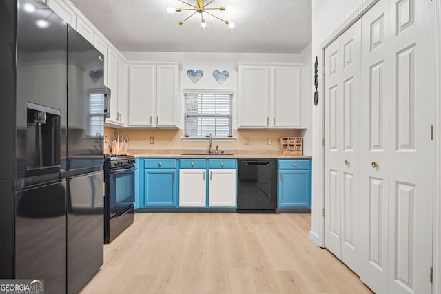 kitchen with black appliances, a textured ceiling, sink, and white cabinets