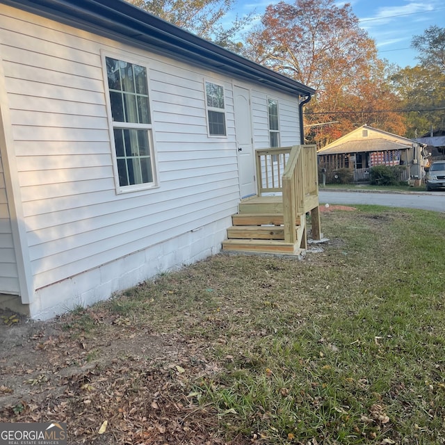 view of side of home with a lawn