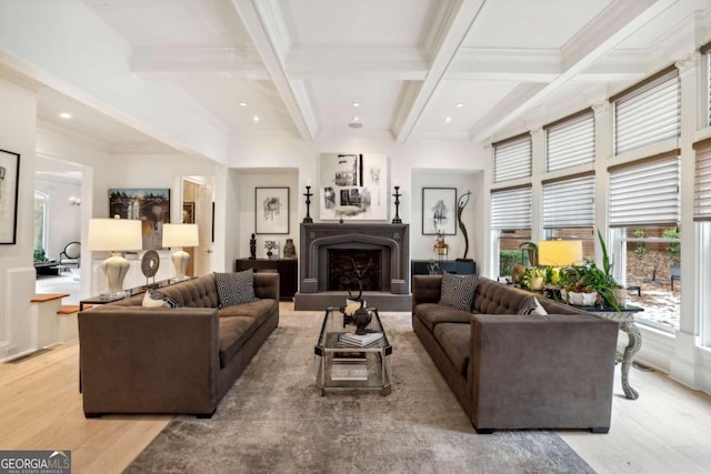 living room with beamed ceiling, coffered ceiling, ornamental molding, and light hardwood / wood-style flooring