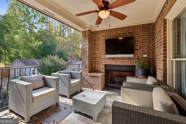 view of patio / terrace with an outdoor living space with a fireplace and ceiling fan