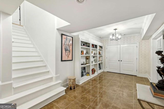 foyer entrance with an inviting chandelier and crown molding