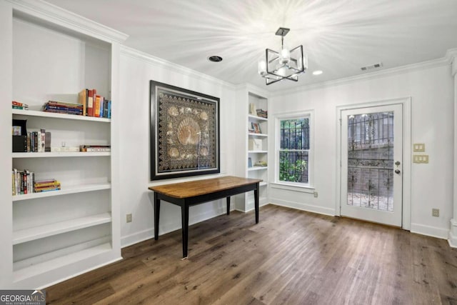 interior space with ornamental molding, built in features, dark hardwood / wood-style floors, and an inviting chandelier