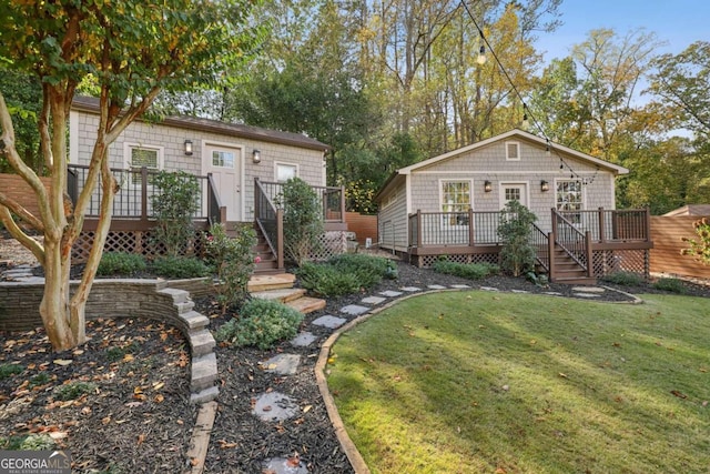 view of front facade with a front lawn and a deck