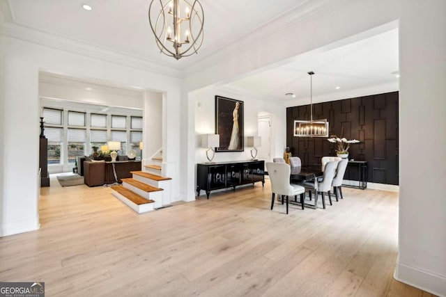 dining room featuring light hardwood / wood-style flooring, a notable chandelier, and crown molding