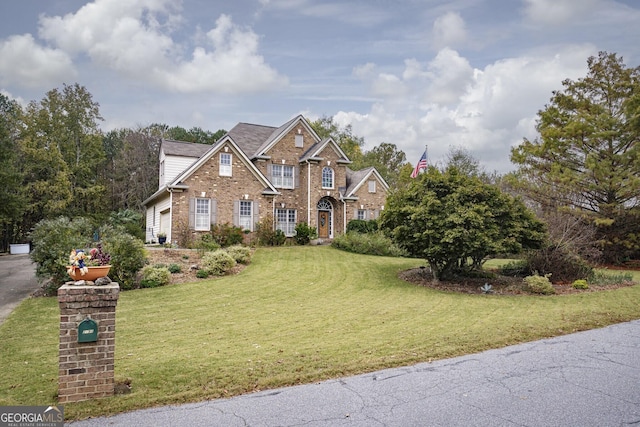 view of front of property featuring a garage and a front lawn