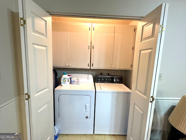 laundry area with washer and clothes dryer and cabinets