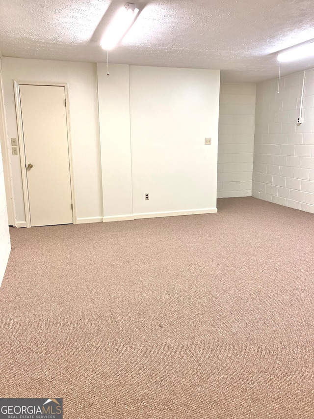 basement featuring a textured ceiling and carpet