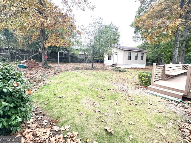 view of yard featuring a deck and an outbuilding