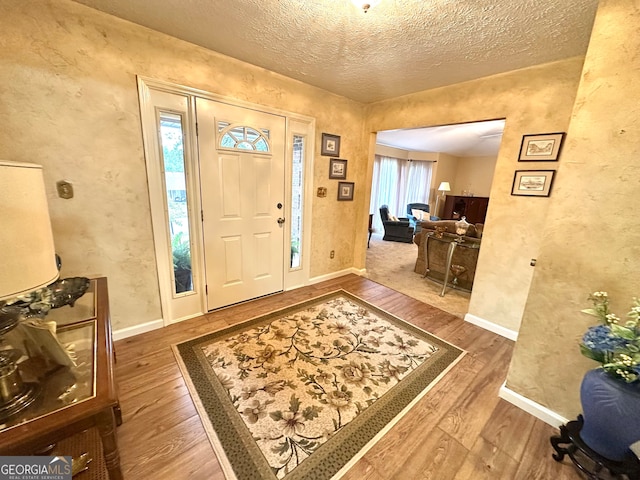 entrance foyer with a textured ceiling and hardwood / wood-style flooring