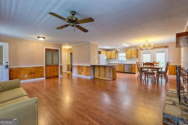 living room with wooden walls, sink, ceiling fan, and light hardwood / wood-style flooring