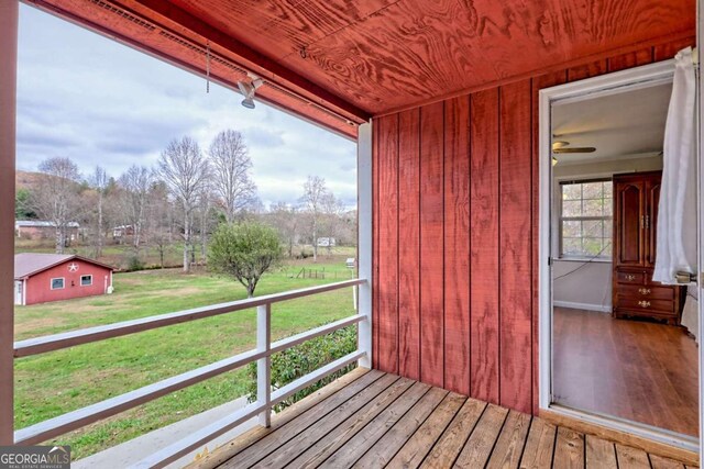 wooden deck with a lawn