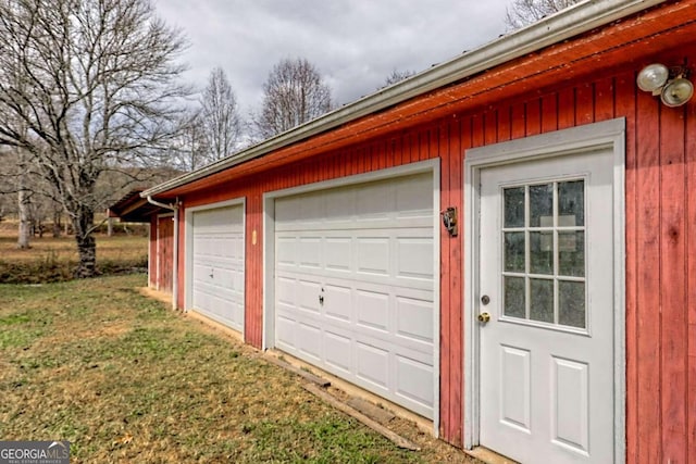 garage featuring a lawn