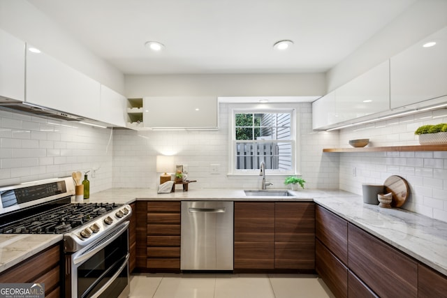 kitchen featuring white cabinetry, appliances with stainless steel finishes, sink, and light tile patterned floors