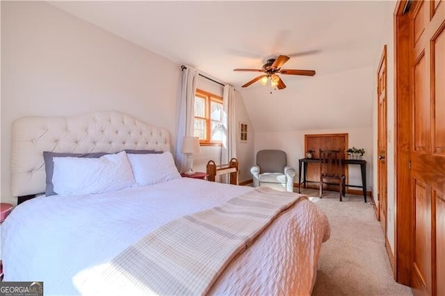 bedroom with light colored carpet, ceiling fan, and vaulted ceiling