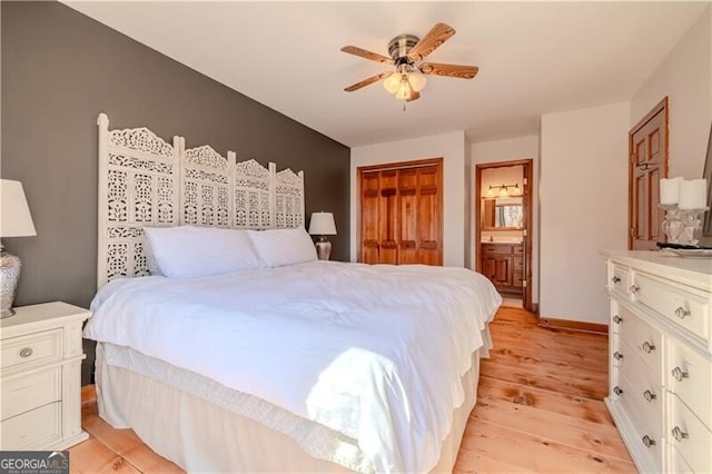 bedroom with light hardwood / wood-style floors, ceiling fan, connected bathroom, and a closet