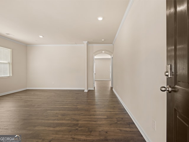 interior space featuring crown molding and dark wood-type flooring