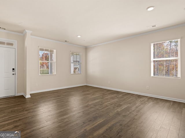 unfurnished room featuring dark hardwood / wood-style floors and crown molding