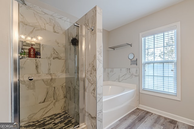 bathroom with plus walk in shower and hardwood / wood-style flooring