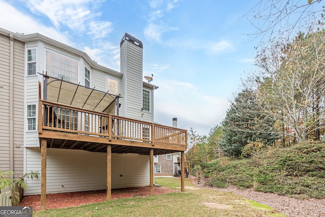 rear view of house featuring a wooden deck