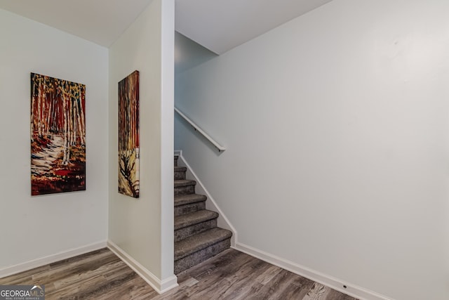 stairs with wood-type flooring