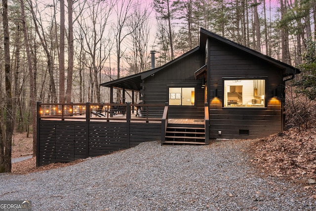 view of front of home with crawl space and a wooden deck