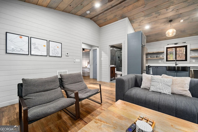 living room with lofted ceiling, wood ceiling, and wood finished floors