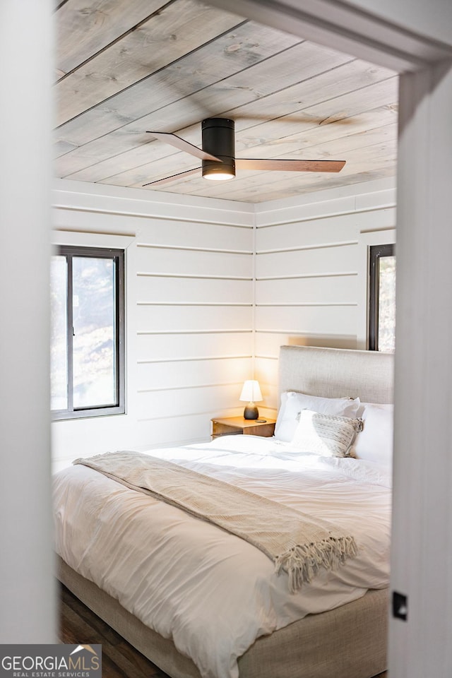 bedroom with wooden walls