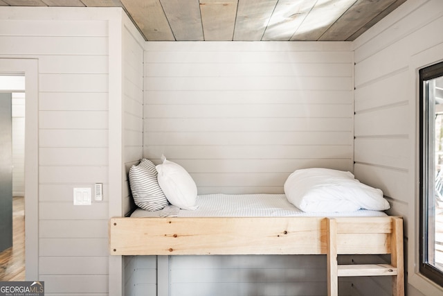 bedroom with wood walls