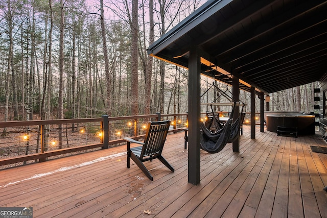 wooden terrace with a hot tub