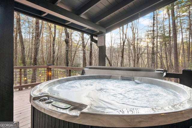 wooden deck featuring a hot tub