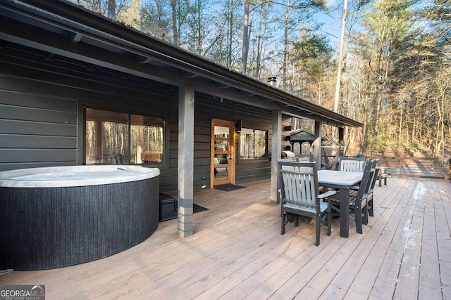 deck with outdoor dining area, central AC, and a hot tub