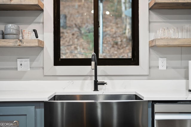 interior details with light countertops and a sink