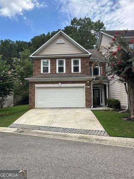 front of property with a garage and a front lawn