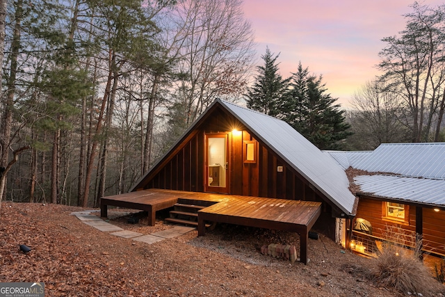 back of house at dusk with metal roof