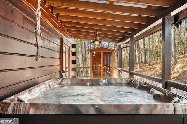 wooden deck with a hot tub