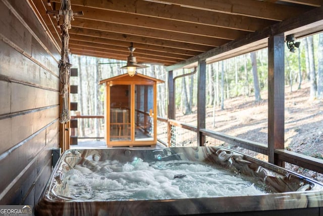 unfurnished sunroom featuring a jacuzzi