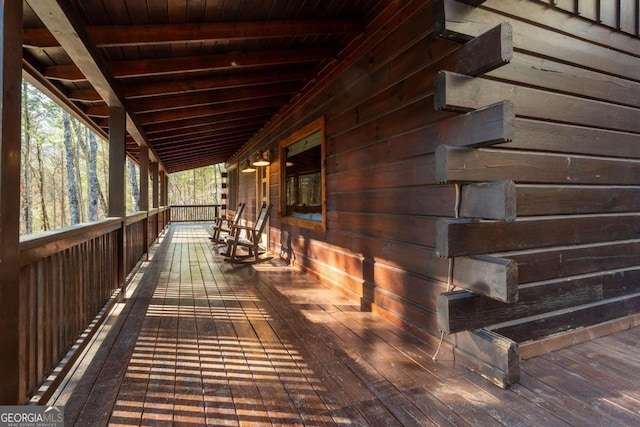 wooden terrace featuring covered porch