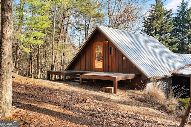 view of property exterior featuring metal roof and board and batten siding