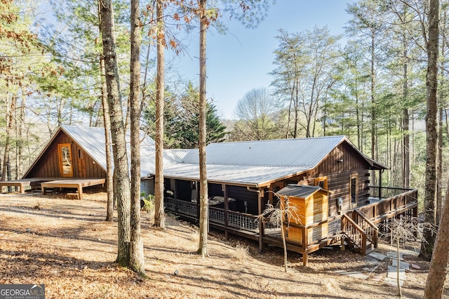 exterior space featuring metal roof and dirt driveway