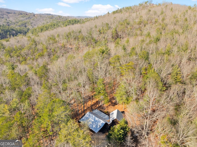 birds eye view of property with a forest view