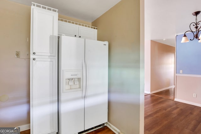 kitchen with white fridge with ice dispenser, white cabinetry, pendant lighting, and dark hardwood / wood-style floors