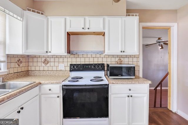 kitchen with white cabinetry, tasteful backsplash, ceiling fan, dark wood-type flooring, and electric stove